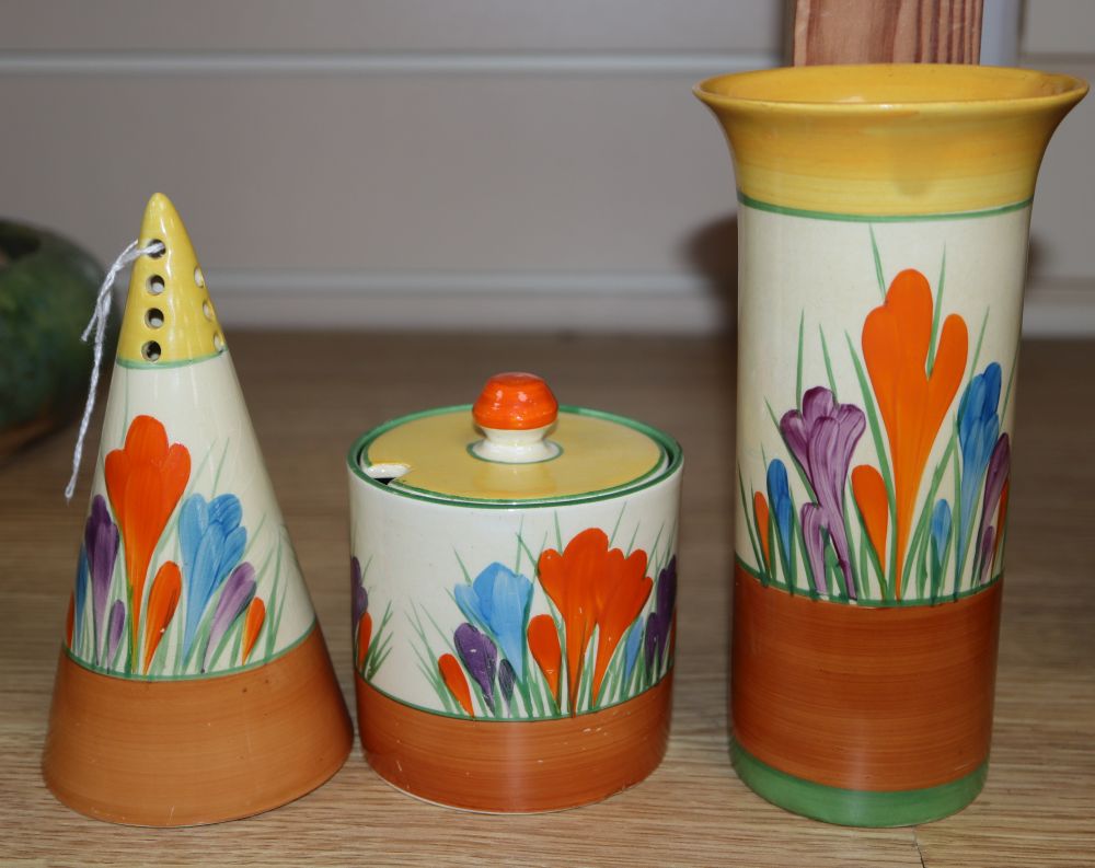 A Clarice Cliff crocus conical caster, preserve jar and a spill vase, tallest 13cm
